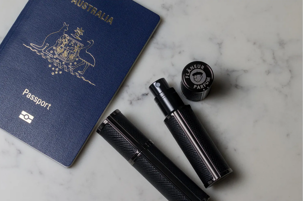 Flâneur Parfum leather travel atomizers with Australian passport on marble surface showing engraved brand logo cap
