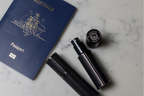 Flâneur Parfum leather travel atomizers with Australian passport on marble surface showing engraved brand logo cap