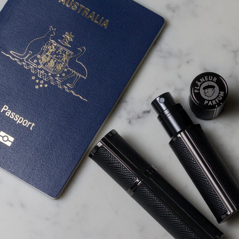 Flâneur Parfum leather travel atomizers with Australian passport on marble surface showing engraved brand logo cap