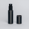 Flâneur Parfum leather travel perfume atomizer 5ml with cap removed on grey background