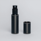 Flâneur Parfum leather travel perfume atomizer 5ml with cap removed on grey background