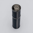 Flâneur Parfum leather travel atomizer top view showing engraved brand logo on aluminium cap