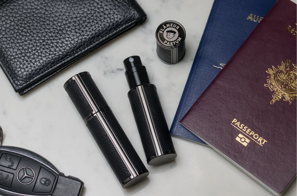 Flâneur Parfum leather travel atomizers with Australian and French passports, leather wallet and Mercedes key on marble surface